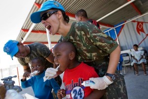 Members of the Brazilian battalion of the United Nations Stabilization Mission in Haiti (MINUSTAH) teach a group of local children proper dental care