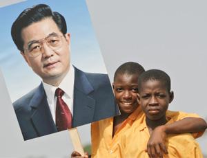 African youth carry a picture of Chinese premier Hu Jintao