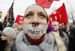 Russian protester with sign that reads &quot;No Voice.&quot;