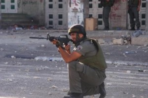 Israeli soldier in the West Bank; photo courtesy IMEMC