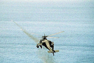 AH-64A Apache gunship firing rockets during exercise.