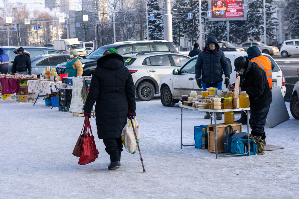 An elderly woman walks through one of Russia's winter markets (Shutterstock)