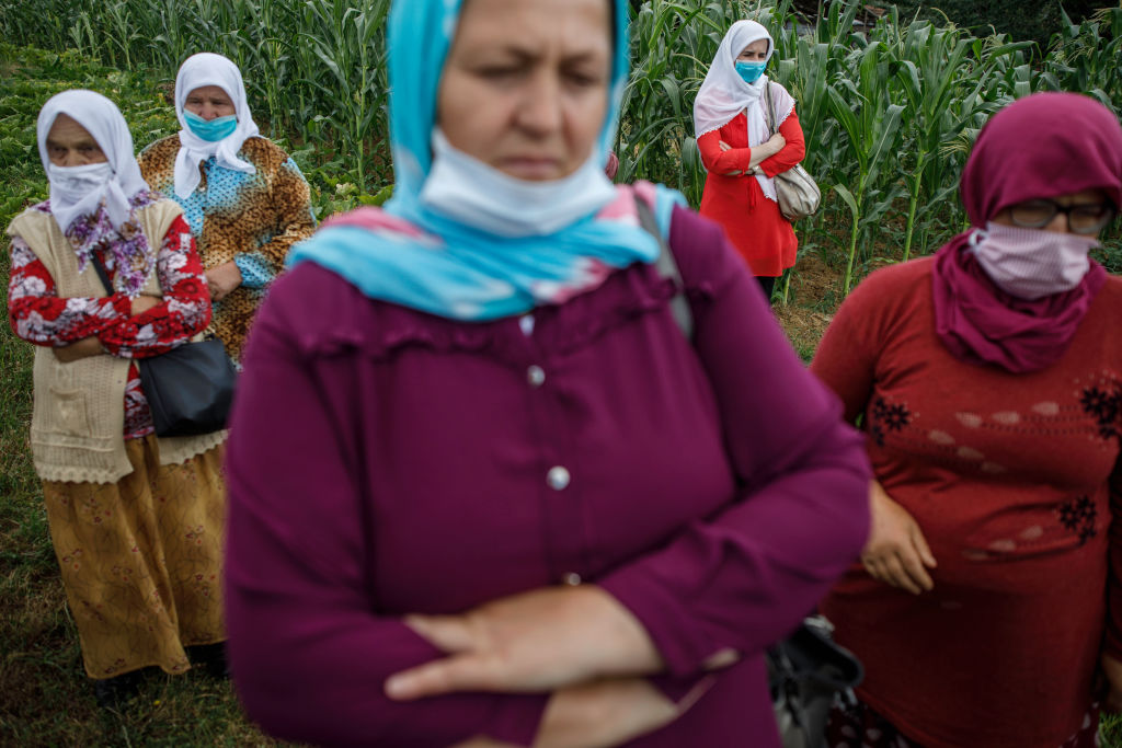 Bosnian Muslim women visit one of the sites of 1995 mass execution of their loved ones, July 2020. (Photo by Damir Sagolj/Getty Images)