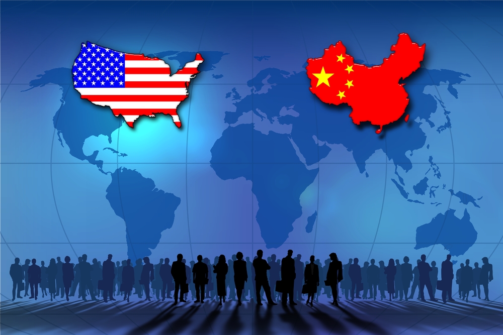 Graphic: The U.S. and Chinese flags highlighted on a world map, with silhouettes standing beneath them