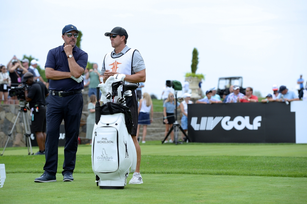 Professional golfer Phil Mickelson (L) talks to his caddie during the LIV Golf Tournament held at the Trump National Golf Club in Bedminster, NJ, in July 2022. (Shutterstock)
